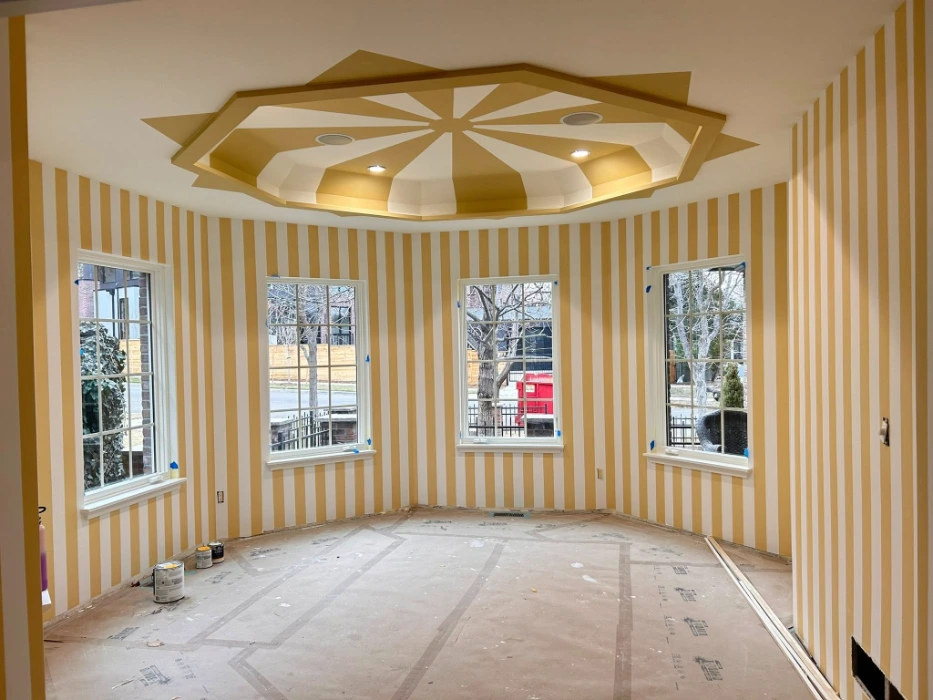 Gold and white striped wallpaper with a matching gold starburst medallion on the tray ceiling of a Denver home