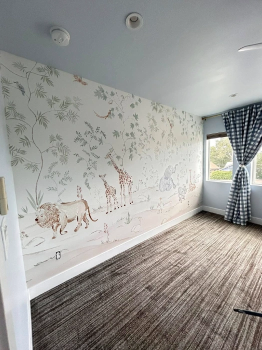 Safari animal mural wallpaper with giraffes and a lion in a Denver kids room