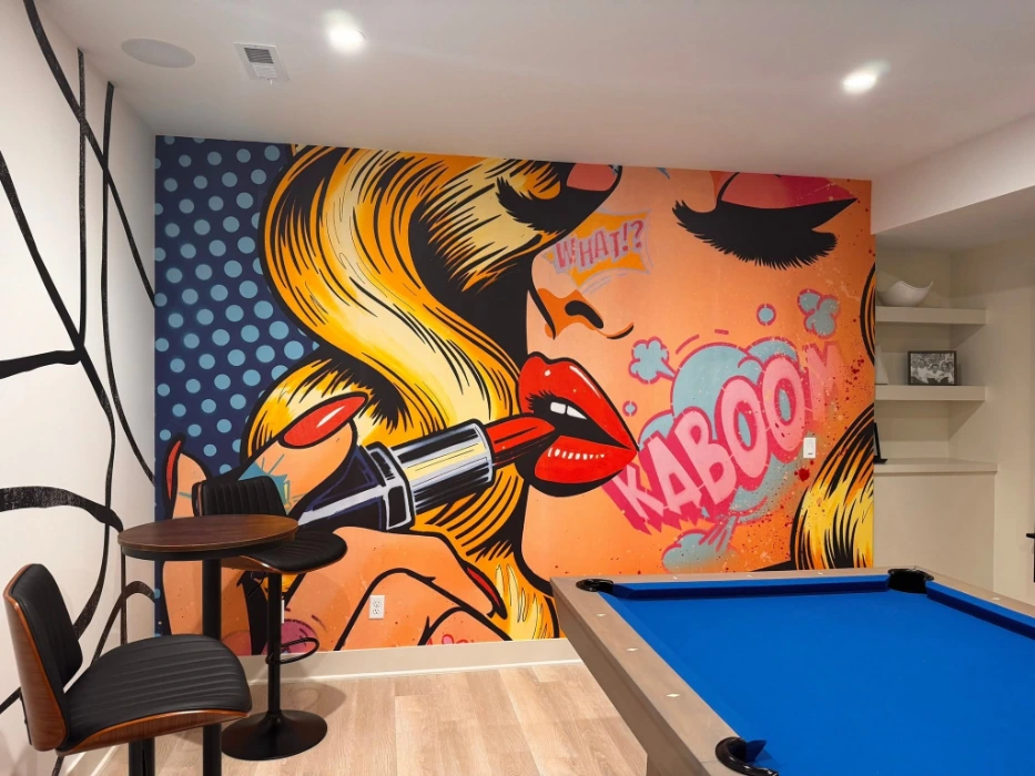 Pop art comic-style KABOOM mural wallpaper on a Denver game room wall beside a pool table
