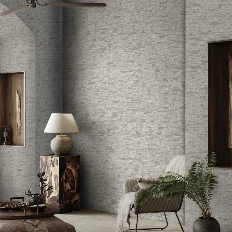 Light grey textured wallpaper covering the walls of a Denver living room with a table lamp and armchair